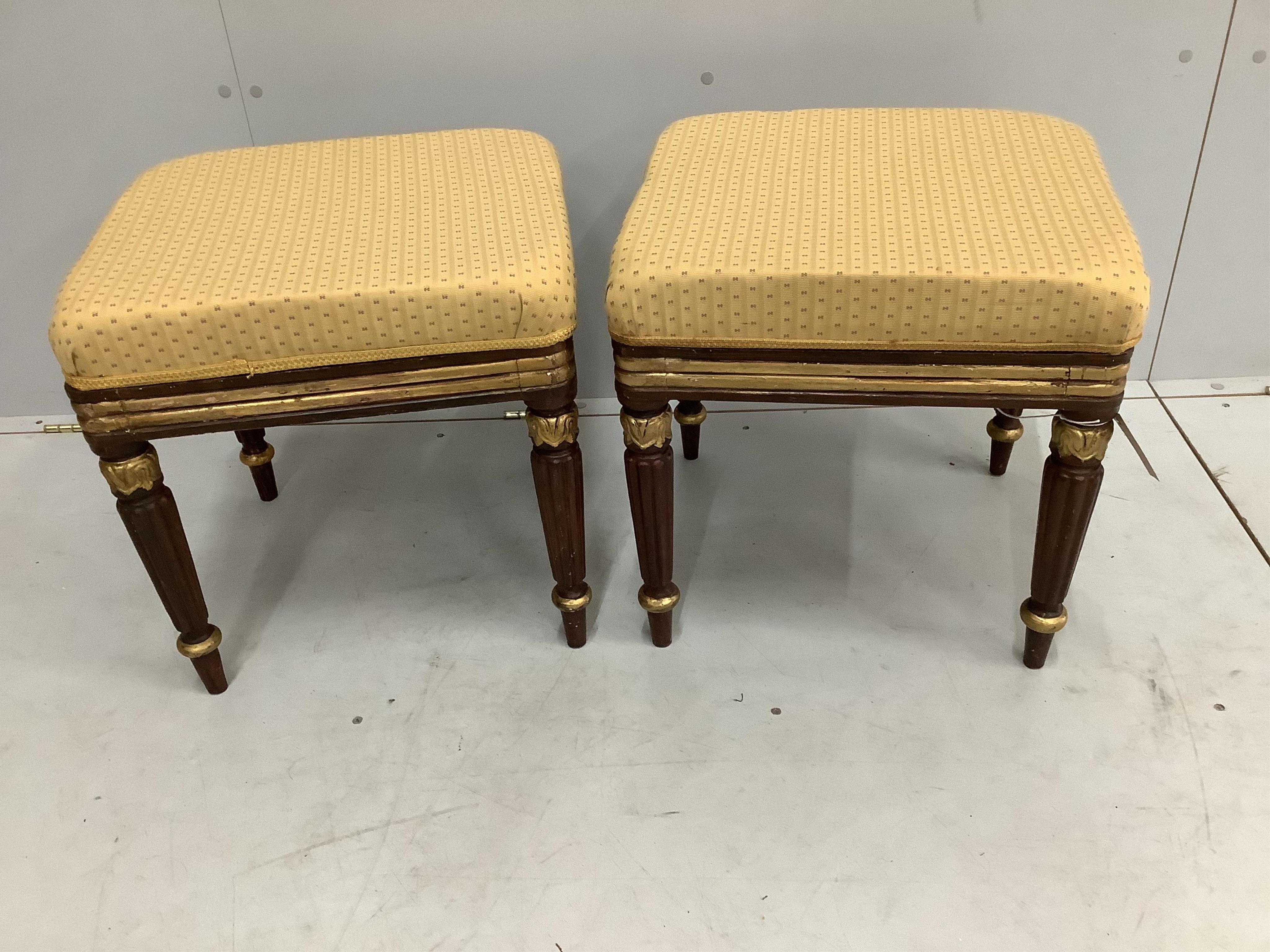 A pair of Regency style parcel gilt mahogany stools on reeded legs, width 45cm, height 46cm